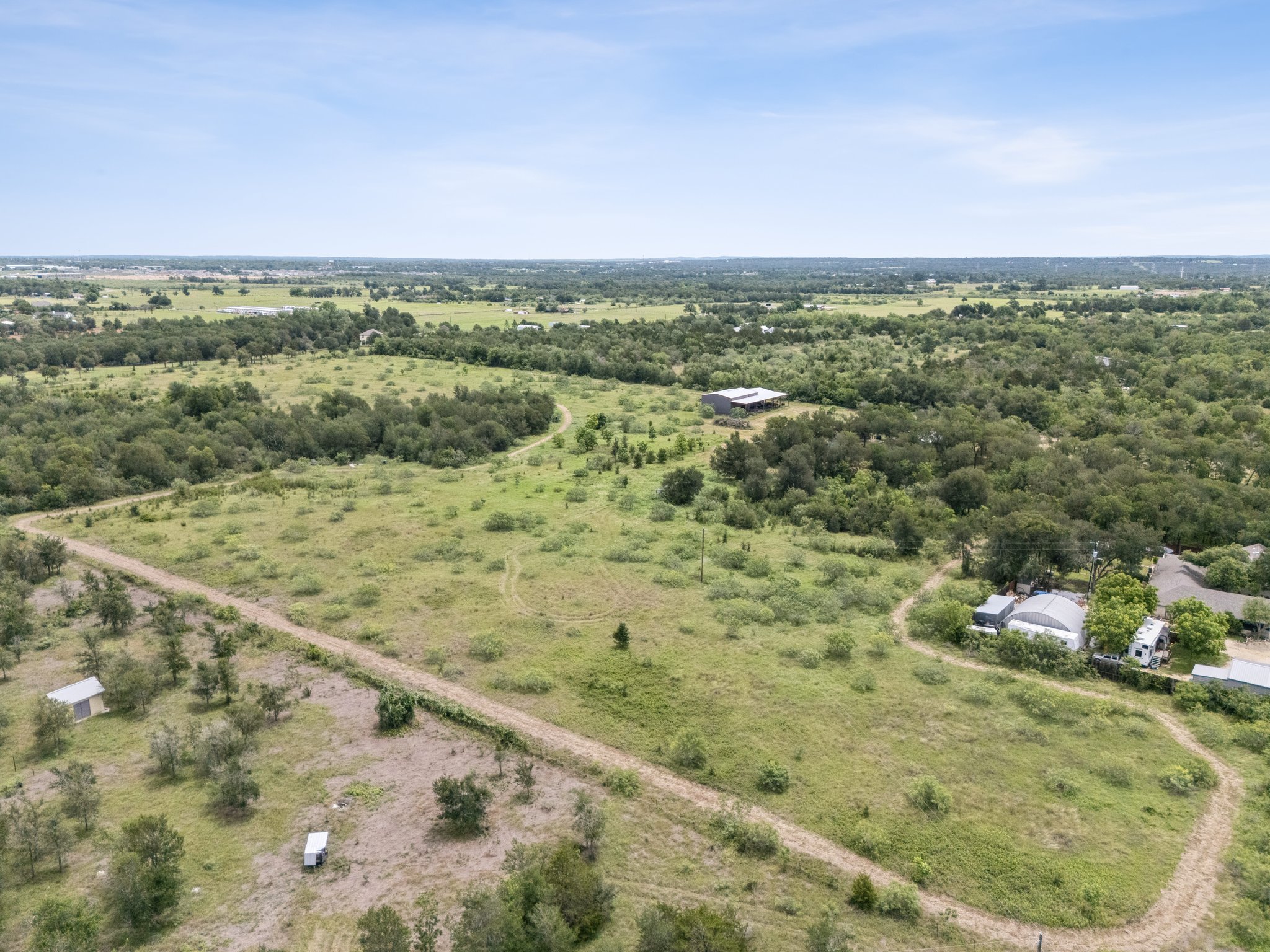 406 Monkey Road Elgin, TX 78621 - Photo 38 of 39 Expansive rural acreage featuring diverse vegetation and multiple structures