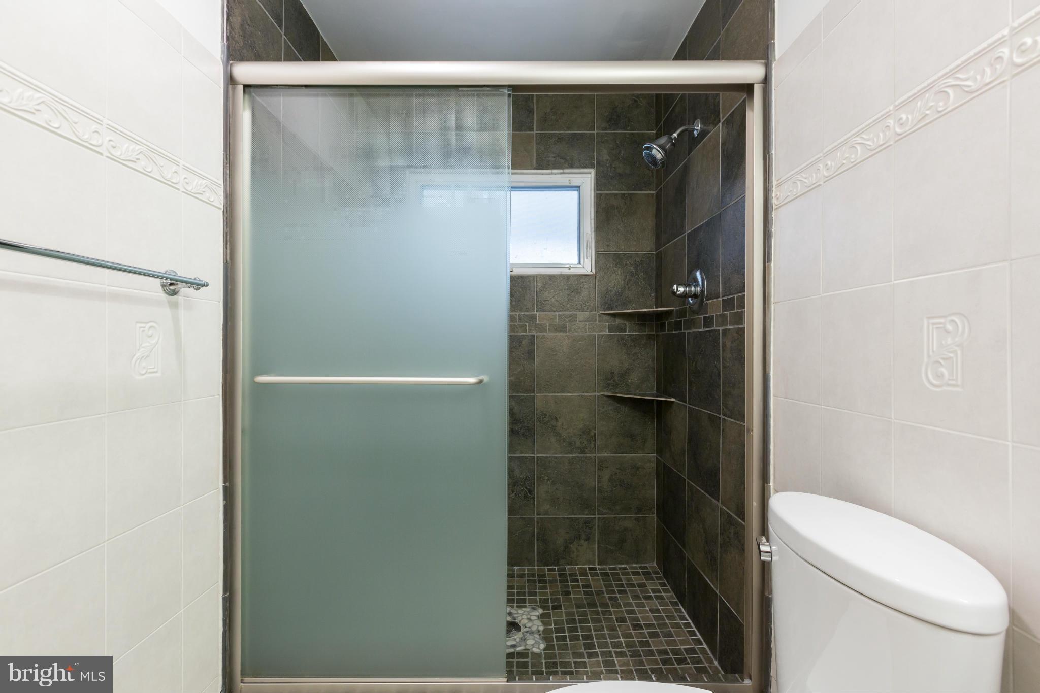 8003 Karl Road Alexandria, VA 22308 - Photo 14 of 30 a bathroom with a shower and toilet