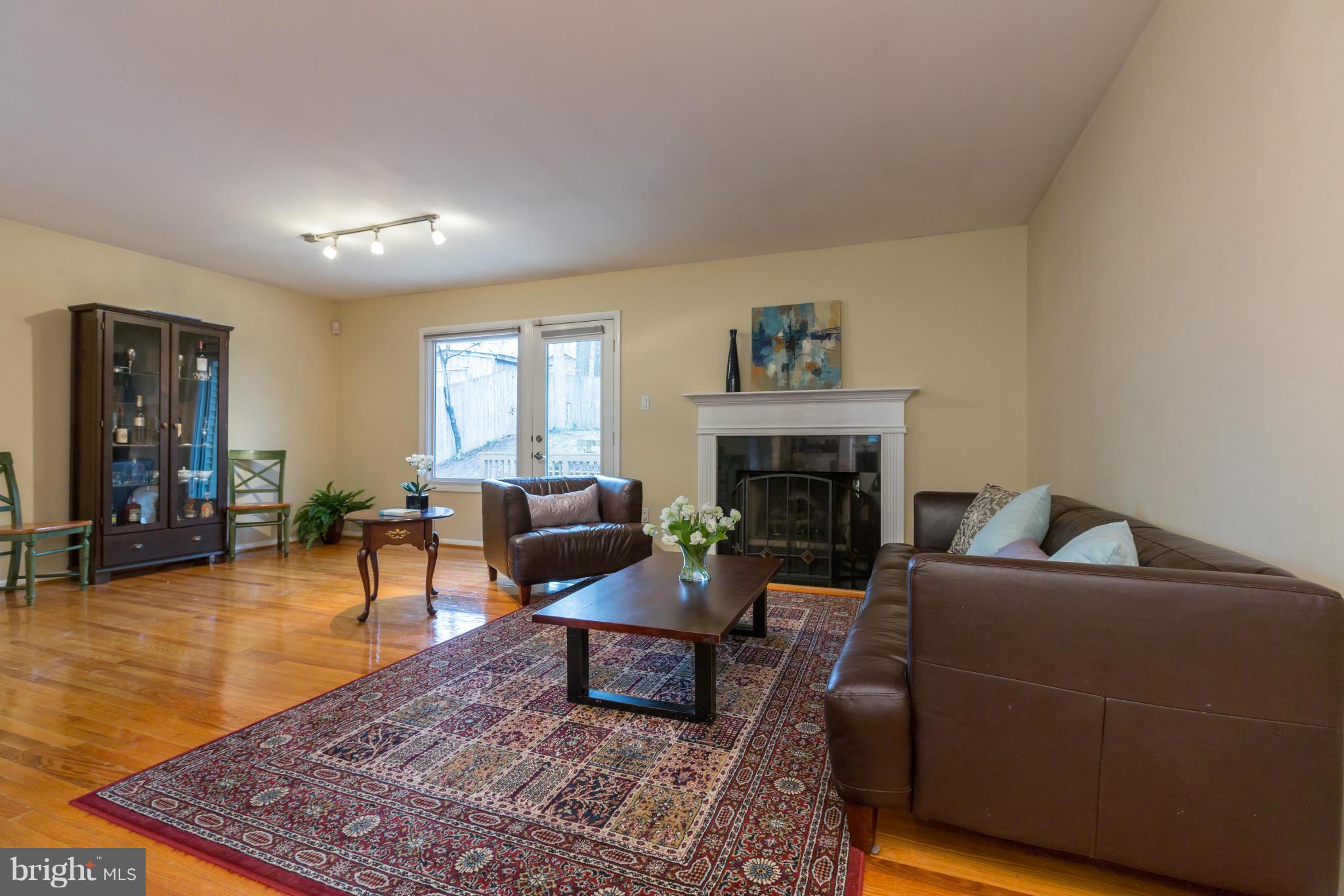 8003 Karl Road Alexandria, VA 22308 - Photo 3 of 30 a living room with furniture and a fireplace