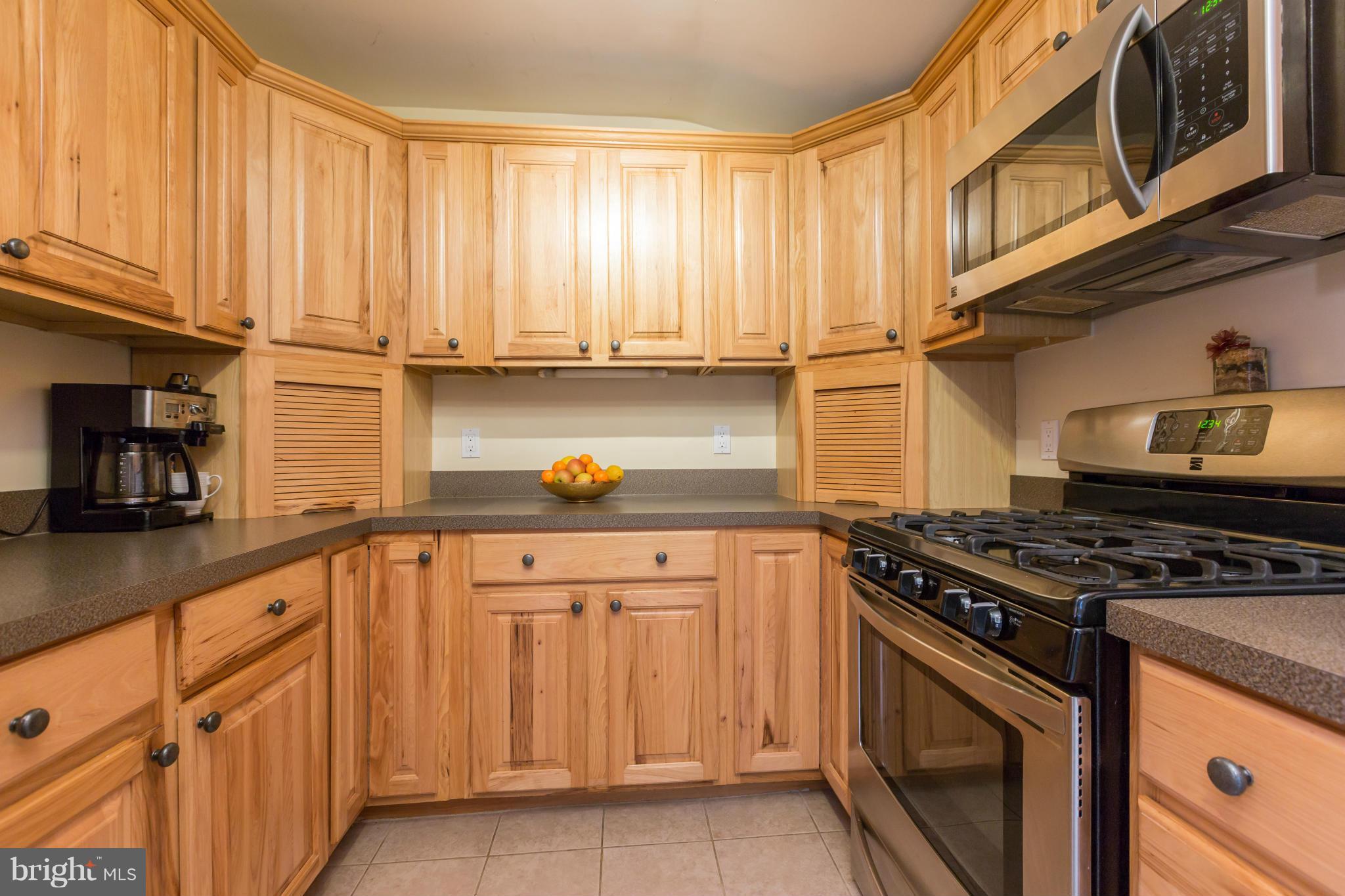 8003 Karl Road Alexandria, VA 22308 - Photo 8 of 30 a kitchen with granite countertop a sink stove and cabinets