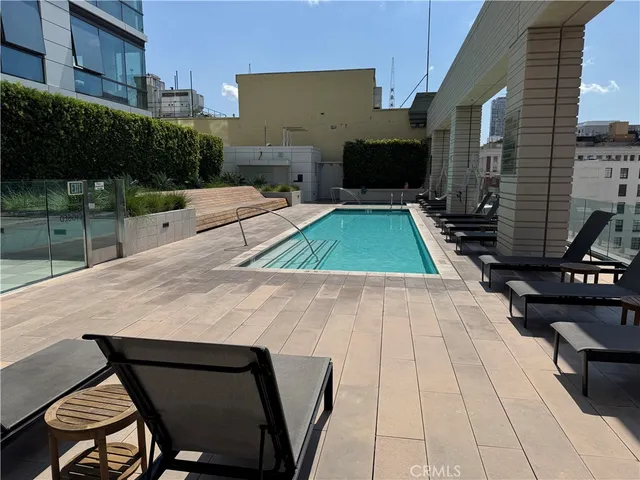 a large white kitchen with stainless steel appliances kitchen island a large counter space a sink and cabinets