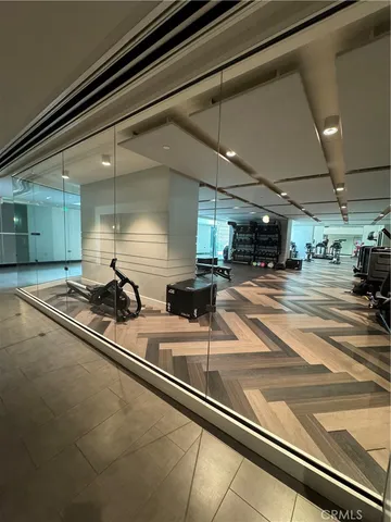 a roof deck with table and chairs and potted plants