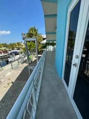 a view of a balcony with chairs