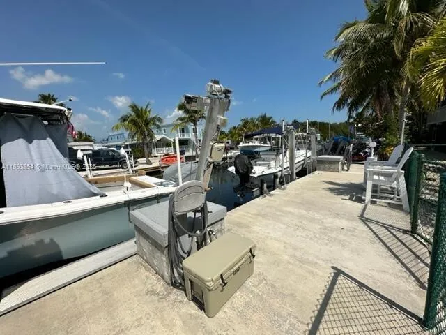 a view of a swimming pool with outdoor seating and plants