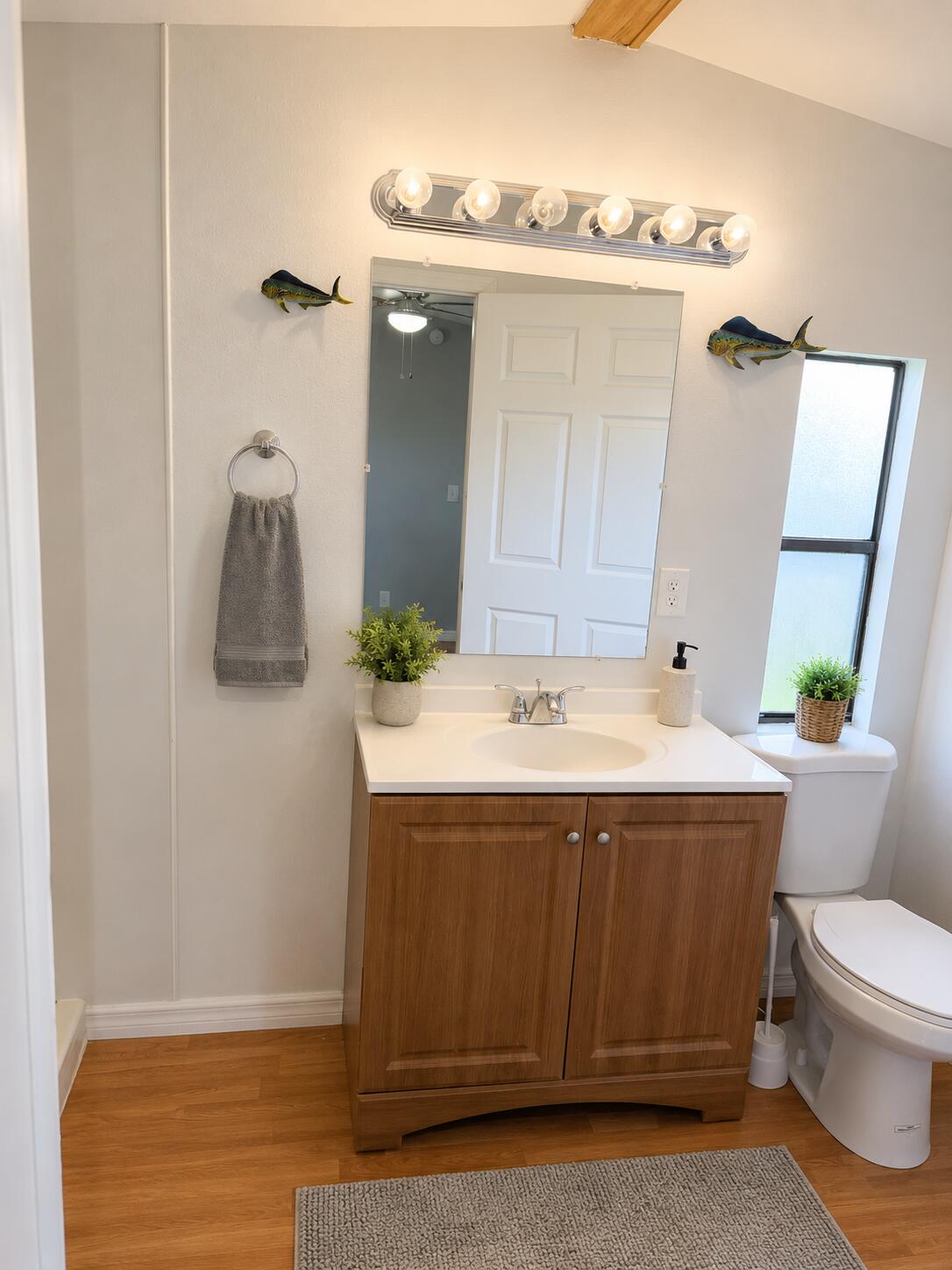 2547 Chatham Way Northeast Palm Bay, FL 32905 - Photo 12 of 24 a bathroom with a sink and mirror with toilet