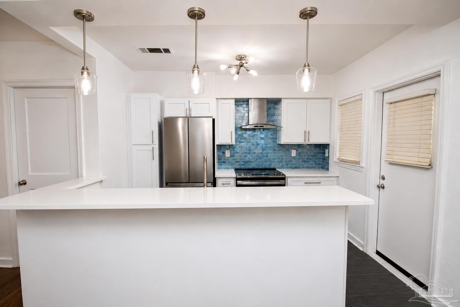315 Flannan Road Pensacola, FL 32507 - Photo 7 of 17 a view of a kitchen with stainless steel appliances granite countertop a refrigerator a sink and a stove