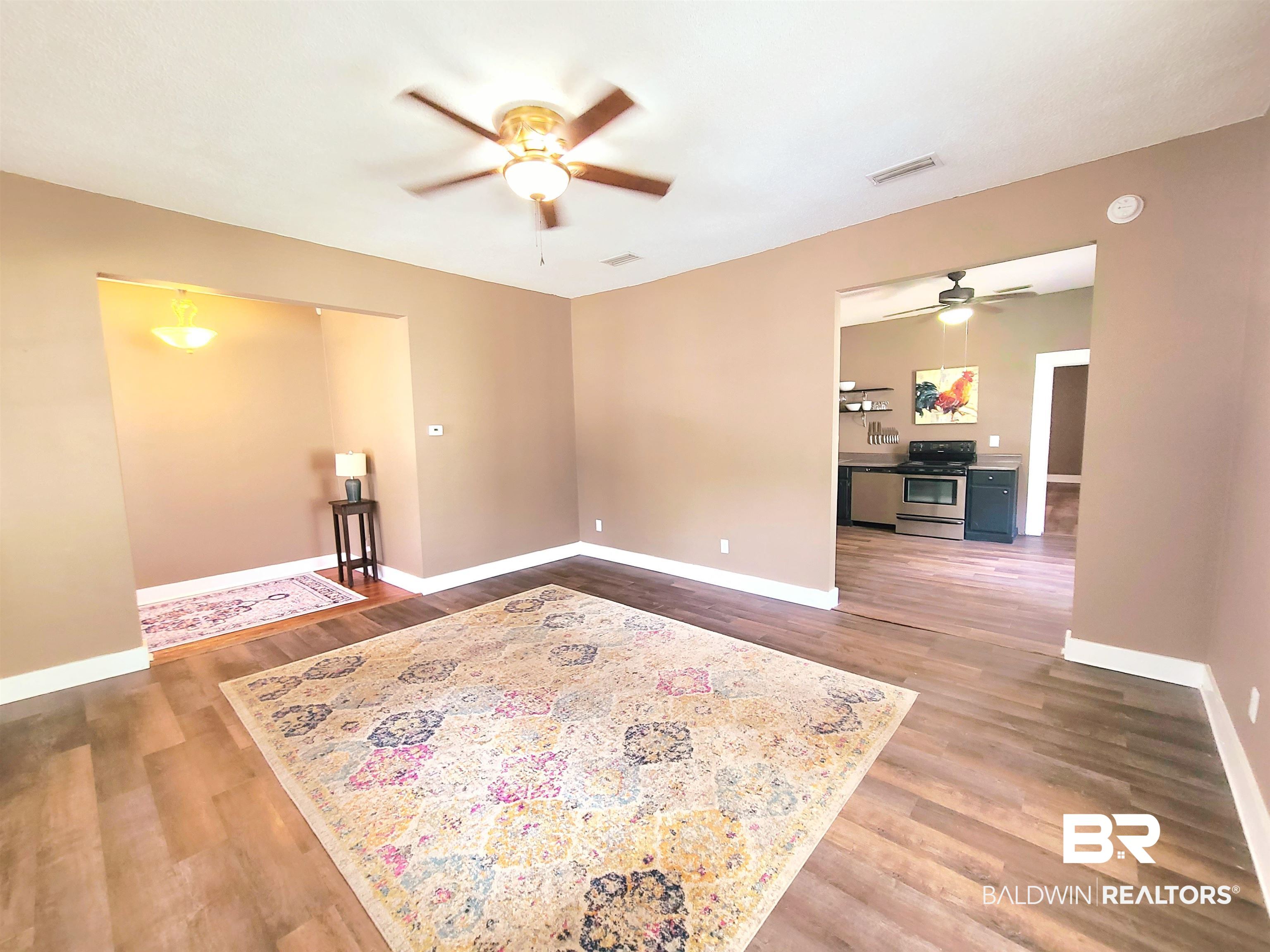 112 Espejo Street Mobile, AL 36604 - Photo 16 of 20 Spare room featuring a ceiling fan, wood finished floors, and baseboards