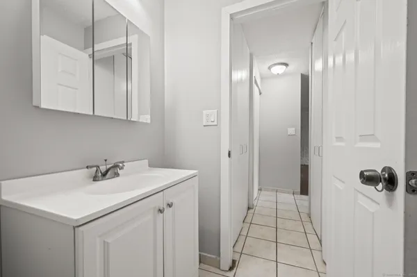 a bathroom with a sink a mirror and a shower