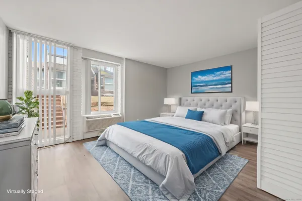 a bedroom with bed and balcony