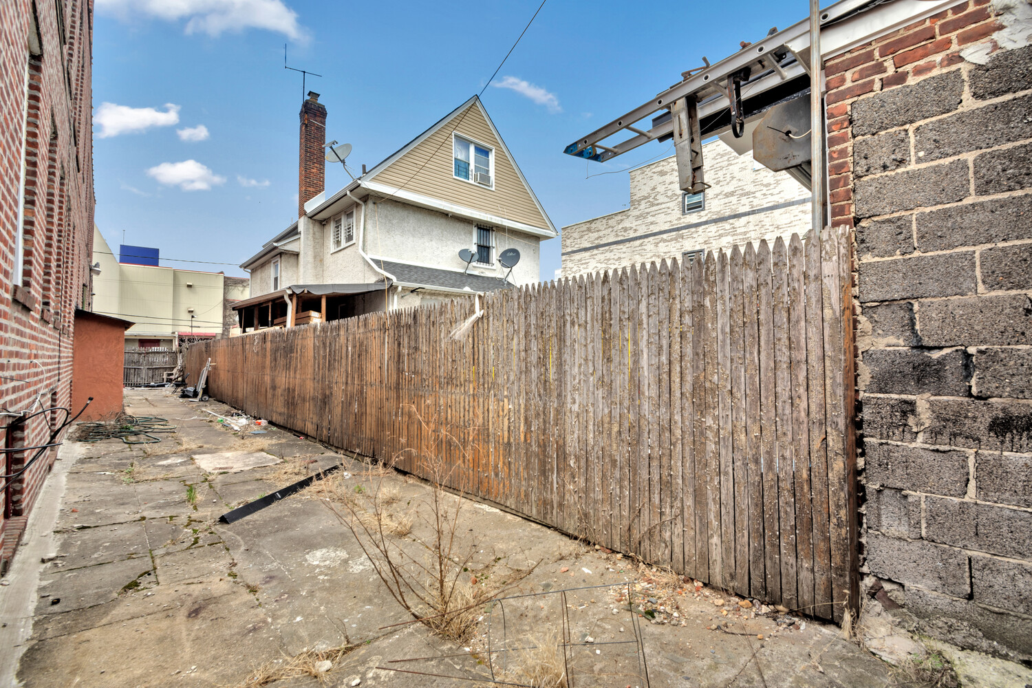 95-07 Cresskill Place Queens, NY 11435 - Photo 8 of 40 a view of a house with a wooden fence