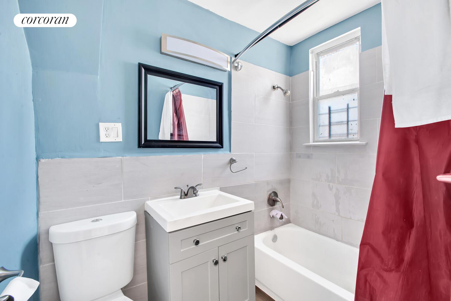 95-07 Cresskill Place Queens, NY 11435 - Photo 16 of 40 a bathroom with a toilet sink and mirror