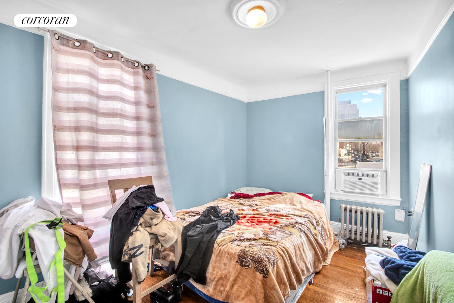 95-07 Cresskill Place Queens, NY 11435 - Photo 21 of 40 a bedroom with two beds and a window