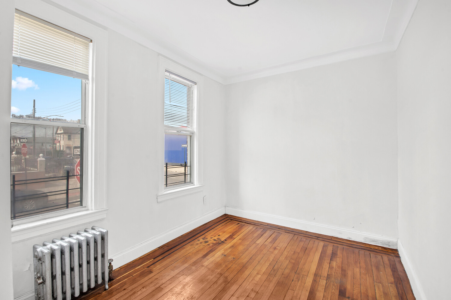 95-07 Cresskill Place Queens, NY 11435 - Photo 25 of 40 a view of an empty room with wooden floor and a window