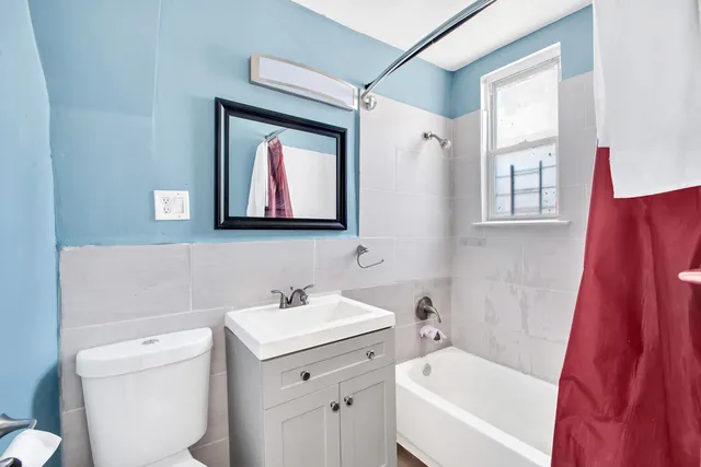 a view of a brick building with a bench in front of it