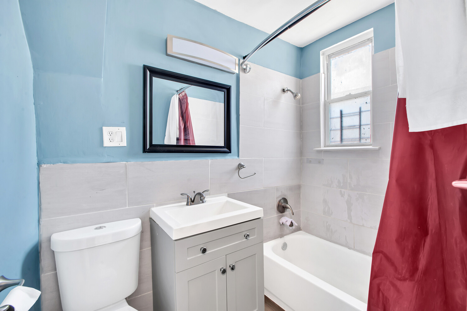 95-07 Cresskill Place Queens, NY 11435 - Photo 27 of 40 a bathroom with a toilet sink and mirror