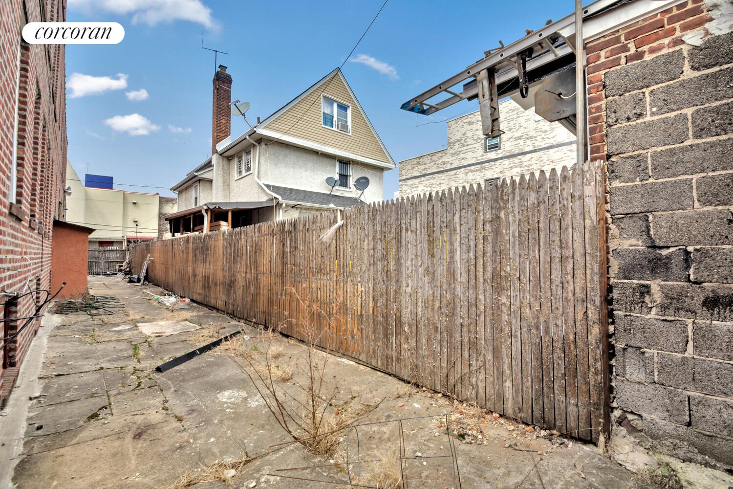 95-07 Cresskill Place Queens, NY 11435 - Photo 4 of 40 a view of a house with a wooden fence