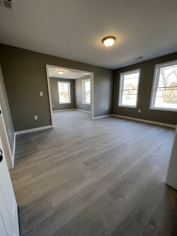 97 Alderman Street Springfield, MA 01108 - Photo 6 of 10 an empty room with windows and entrance