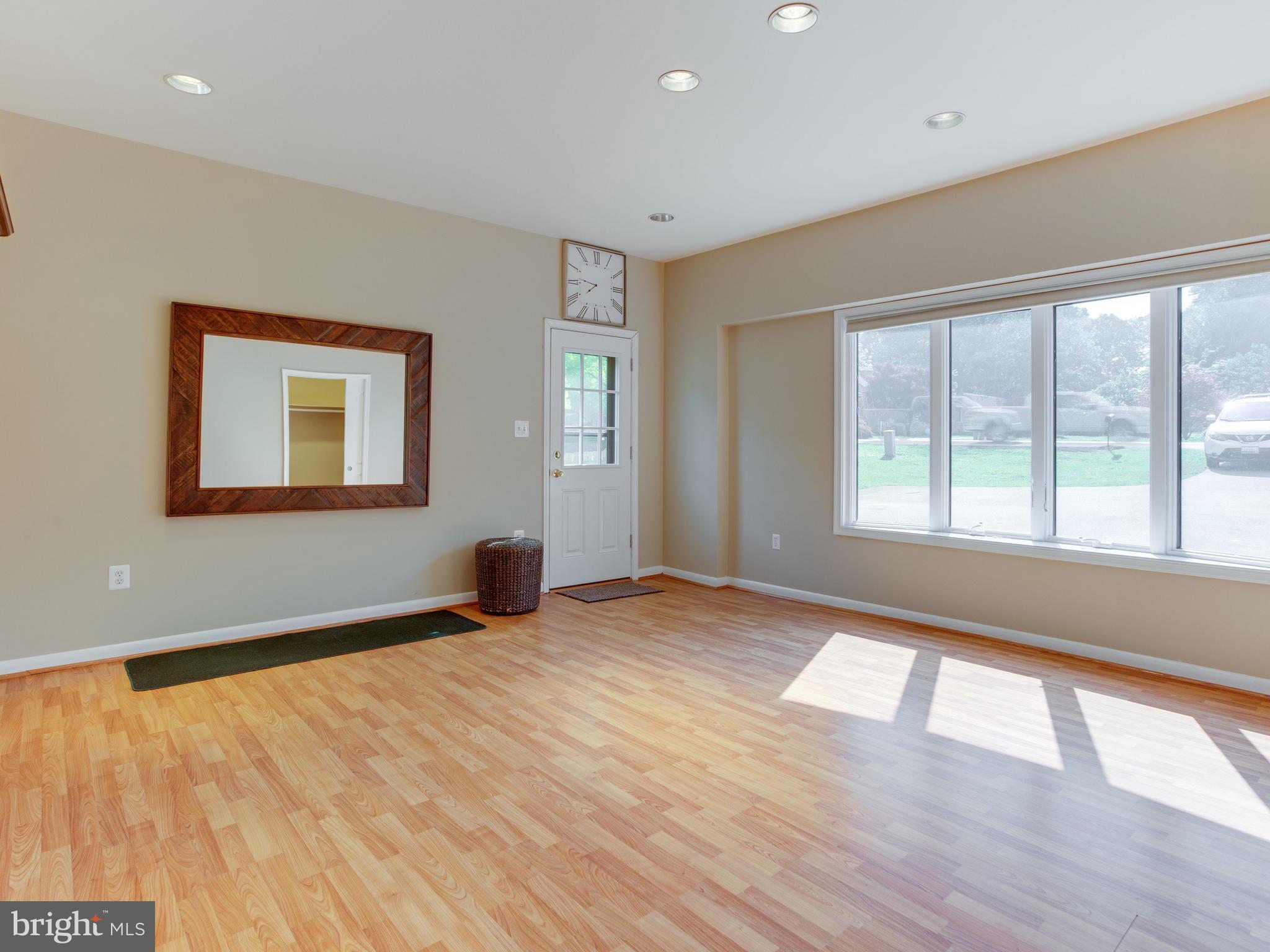 3100 Holland Cliffs Road Huntingtown, MD 20639 - Photo 11 of 44 a view of an empty room with wooden floor and a window