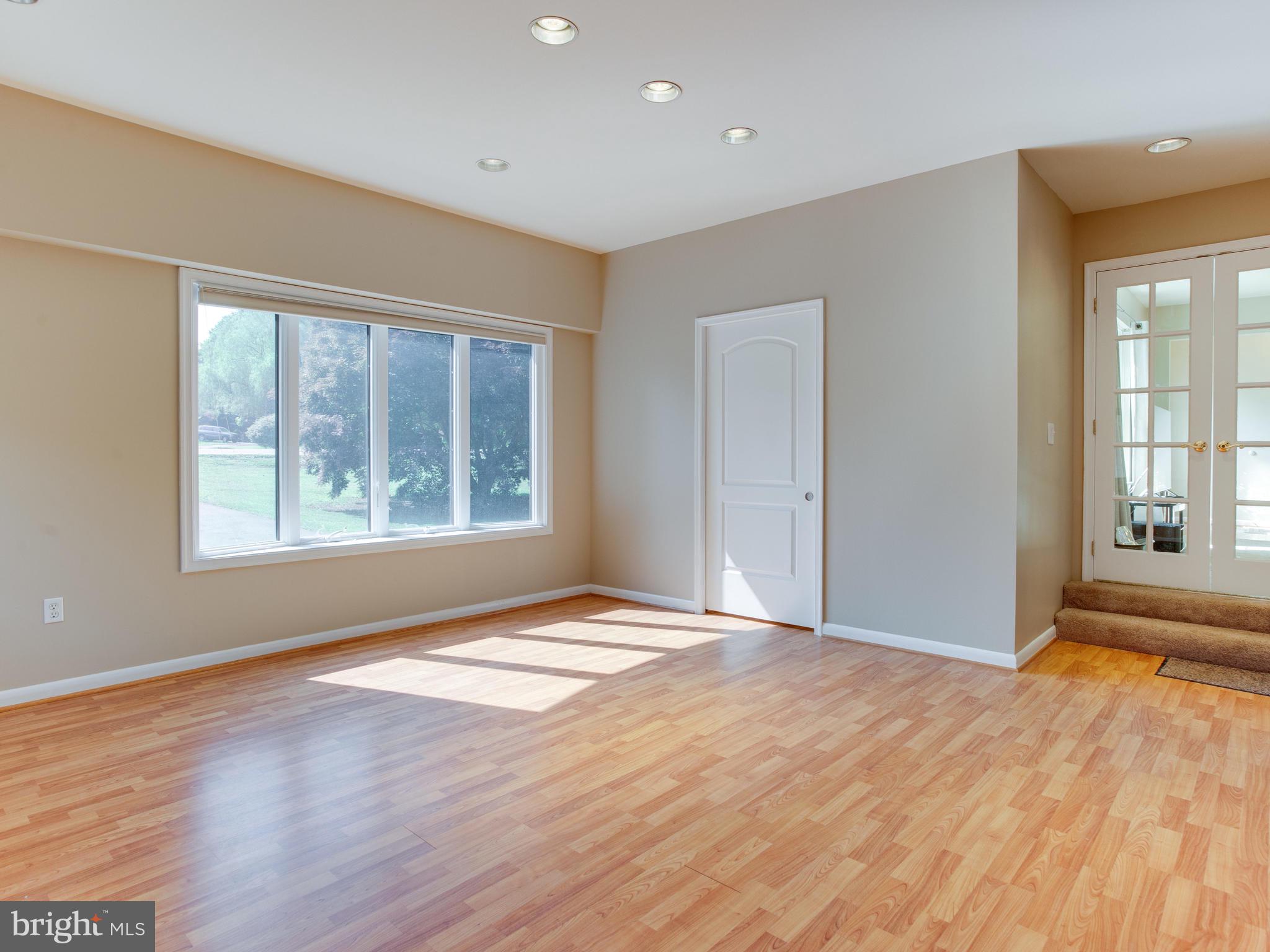 3100 Holland Cliffs Road Huntingtown, MD 20639 - Photo 12 of 44 a view of an empty room with wooden floor and a window