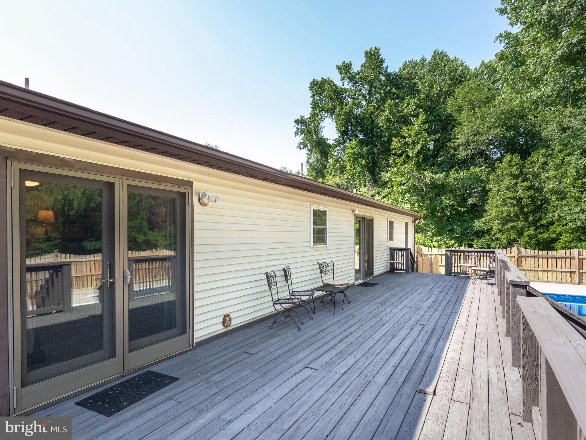 3100 Holland Cliffs Road Huntingtown, MD 20639 - Photo 17 of 44 a backyard of a house with wooden floor yard and outdoor seating