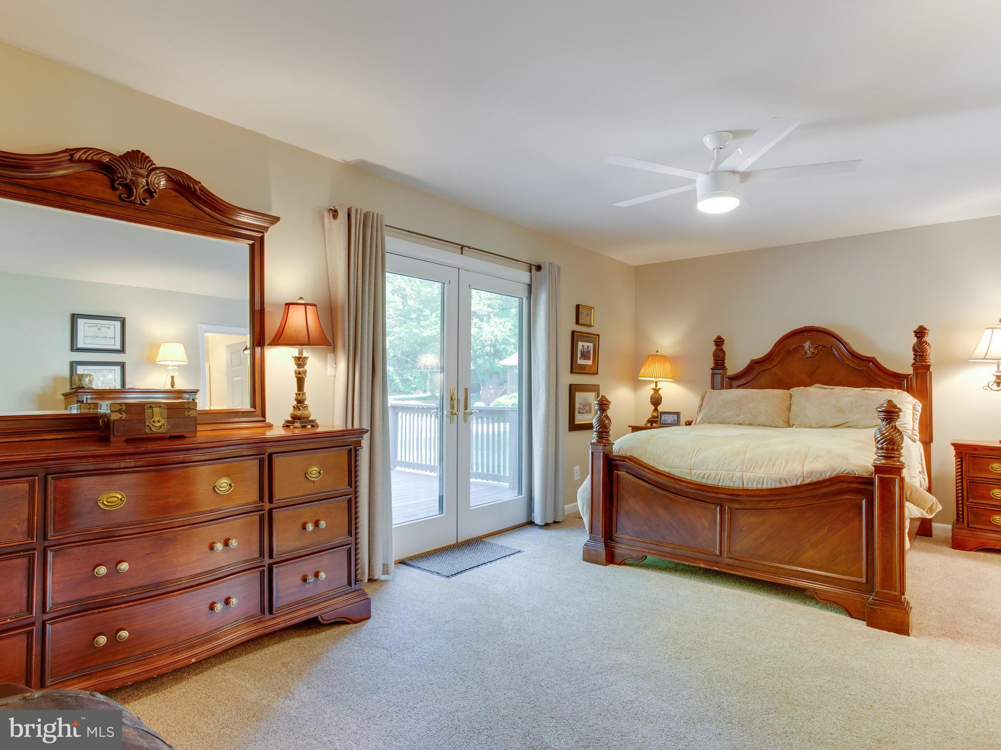 3100 Holland Cliffs Road Huntingtown, MD 20639 - Photo 20 of 44 a spacious bedroom with a bed and a dresser in it