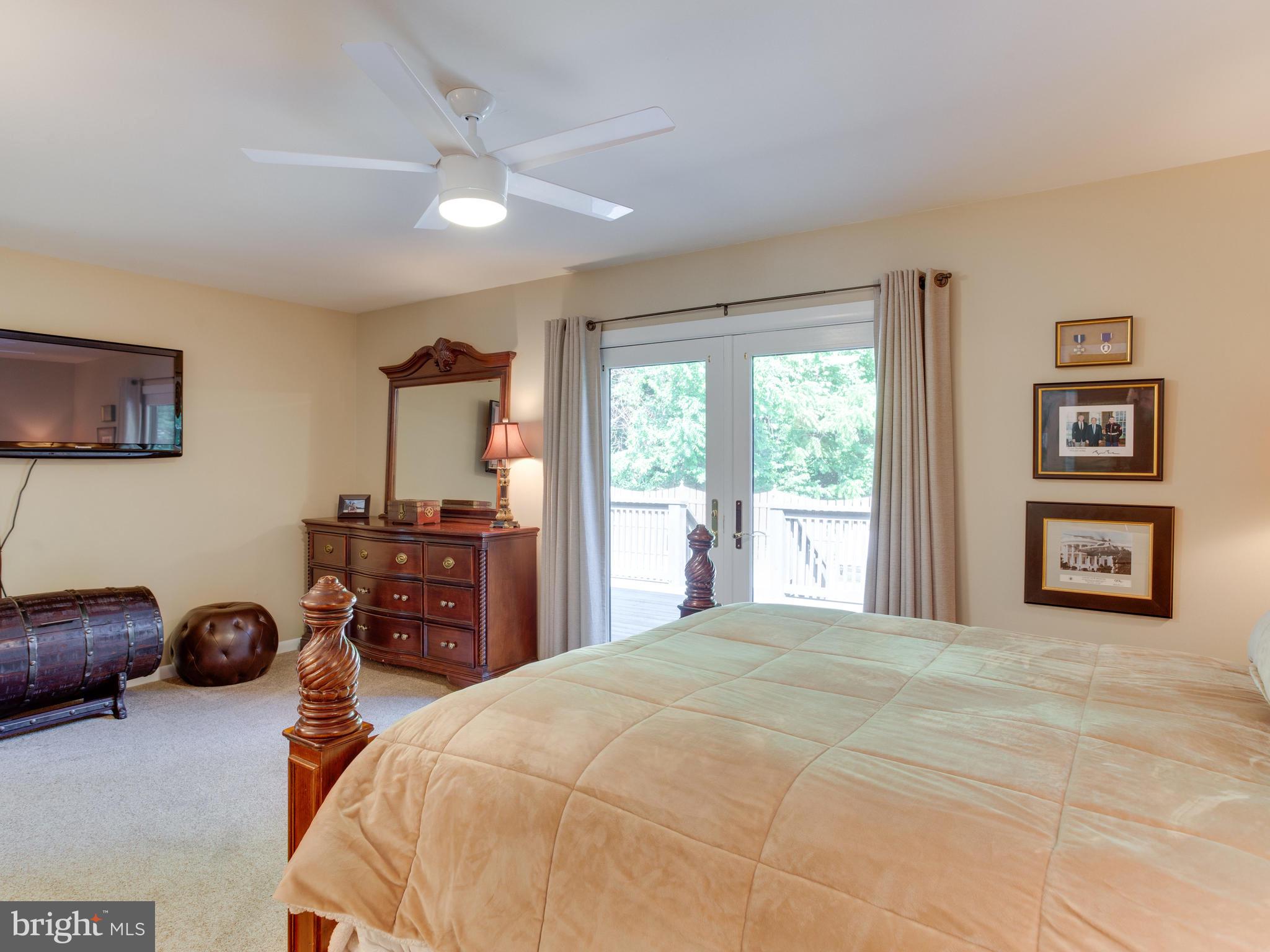 3100 Holland Cliffs Road Huntingtown, MD 20639 - Photo 21 of 44 a bedroom with a bed and a tv on the dresser
