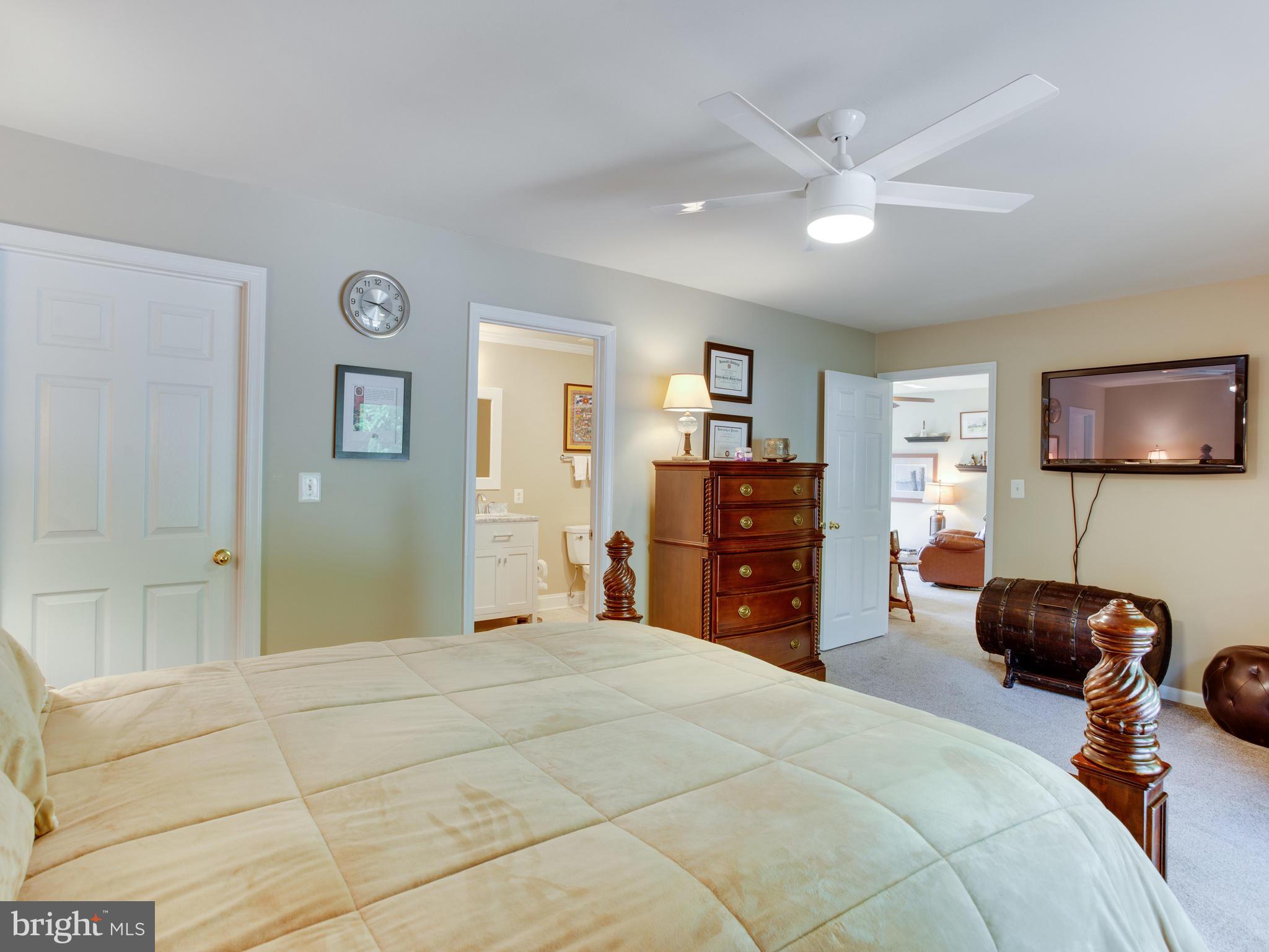 3100 Holland Cliffs Road Huntingtown, MD 20639 - Photo 22 of 44 a bedroom with a bed and a chandelier