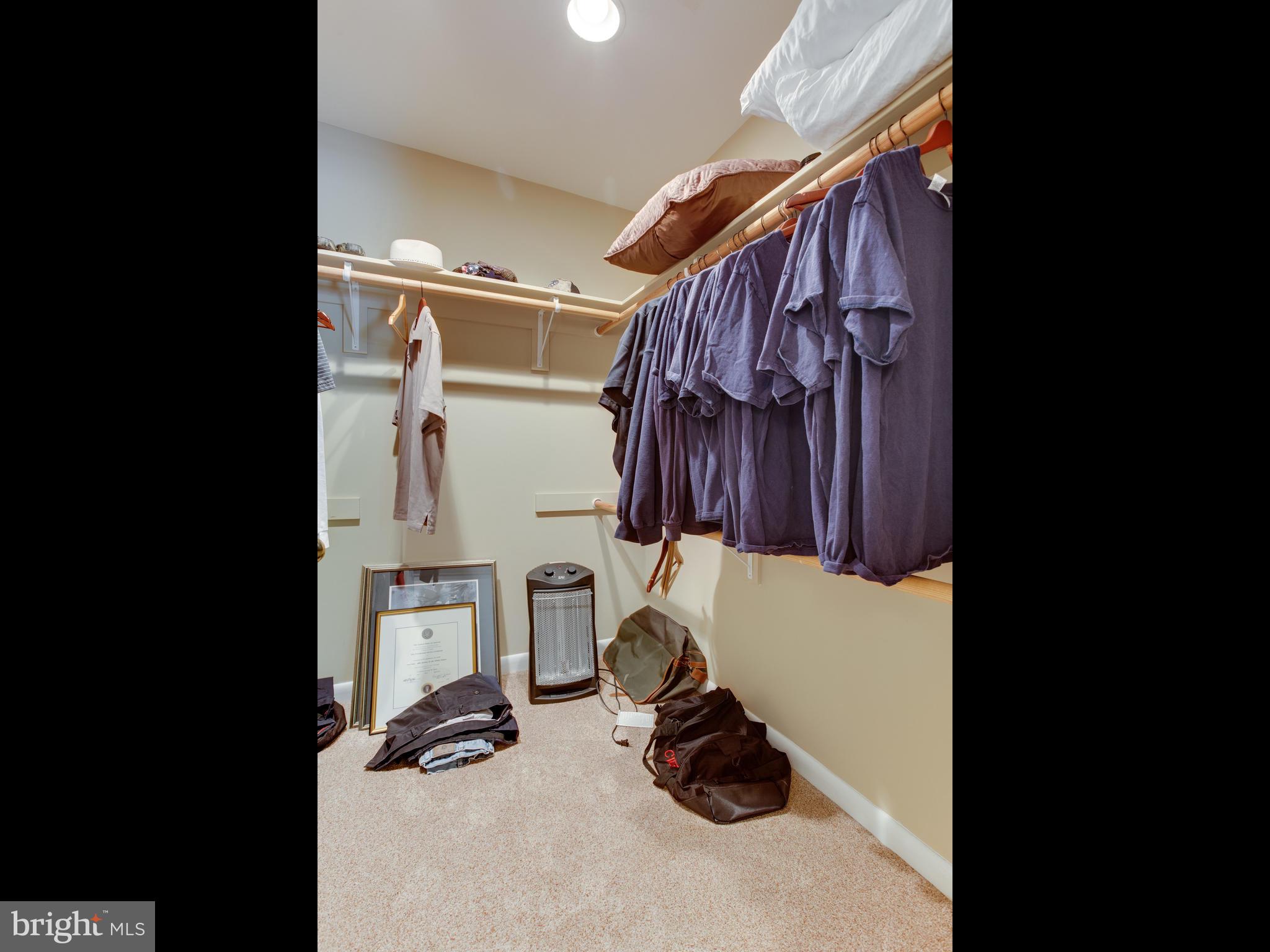 3100 Holland Cliffs Road Huntingtown, MD 20639 - Photo 24 of 44 a view of walk in closet with clothes and shoes
