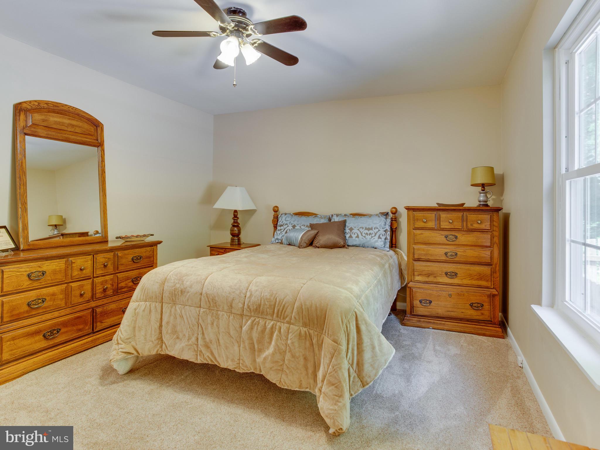 3100 Holland Cliffs Road Huntingtown, MD 20639 - Photo 25 of 44 a bedroom with a bed and a dresser