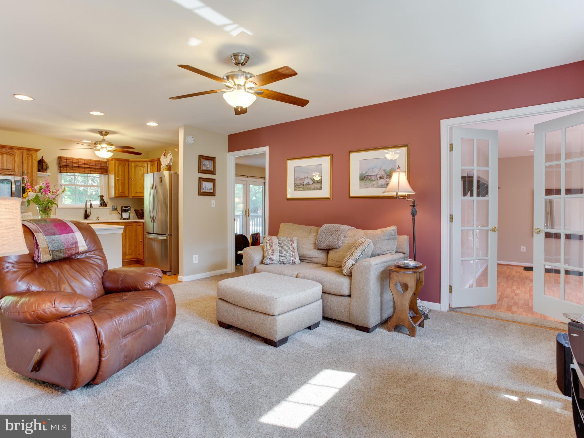 3100 Holland Cliffs Road Huntingtown, MD 20639 - Photo 44 of 44 a living room with furniture and a large mirror