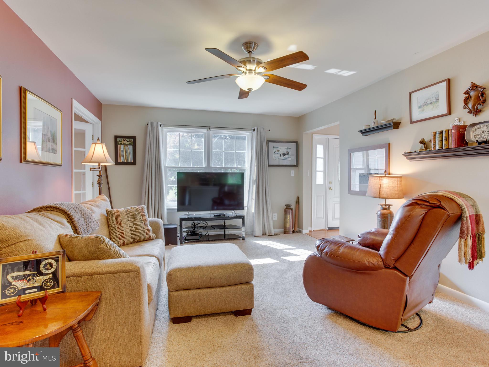 3100 Holland Cliffs Road Huntingtown, MD 20639 - Photo 5 of 44 a living room with furniture and a flat screen tv