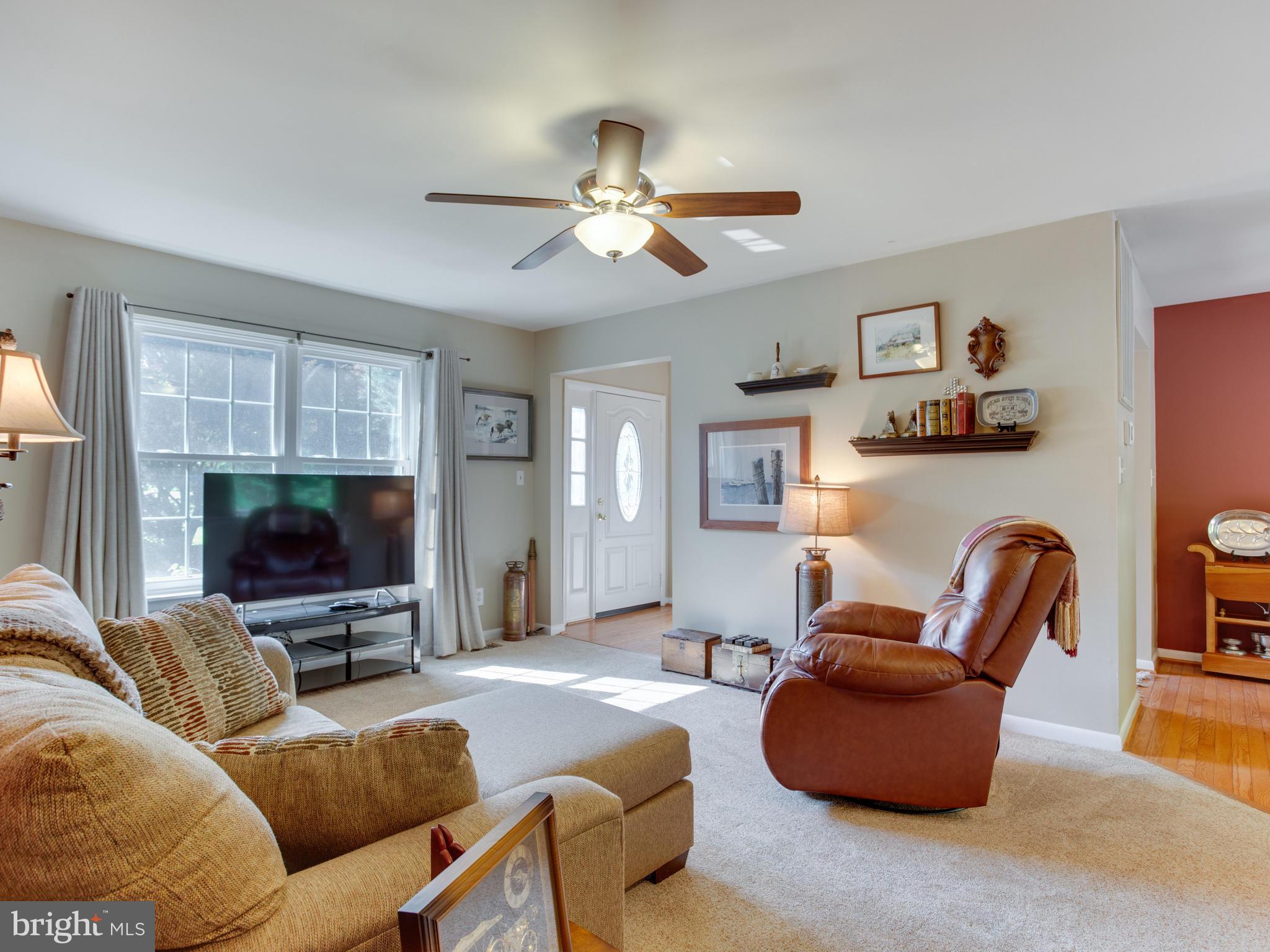 3100 Holland Cliffs Road Huntingtown, MD 20639 - Photo 6 of 44 a living room with furniture and a flat screen tv