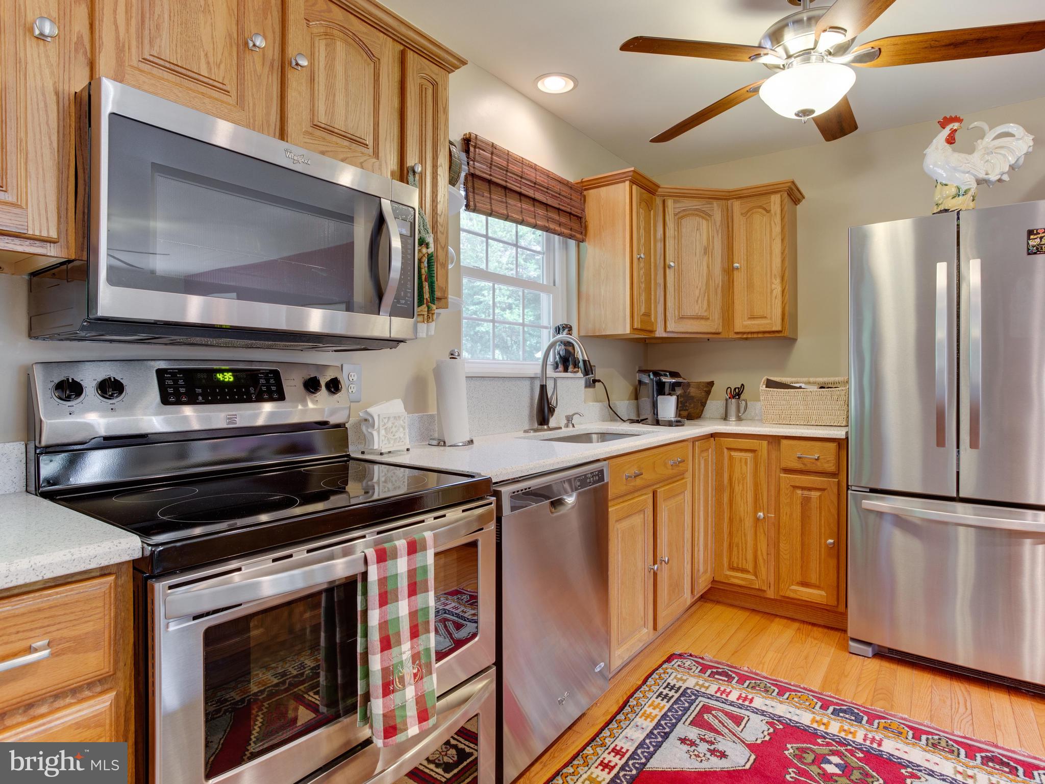 3100 Holland Cliffs Road Huntingtown, MD 20639 - Photo 8 of 44 a kitchen with a stove microwave and sink