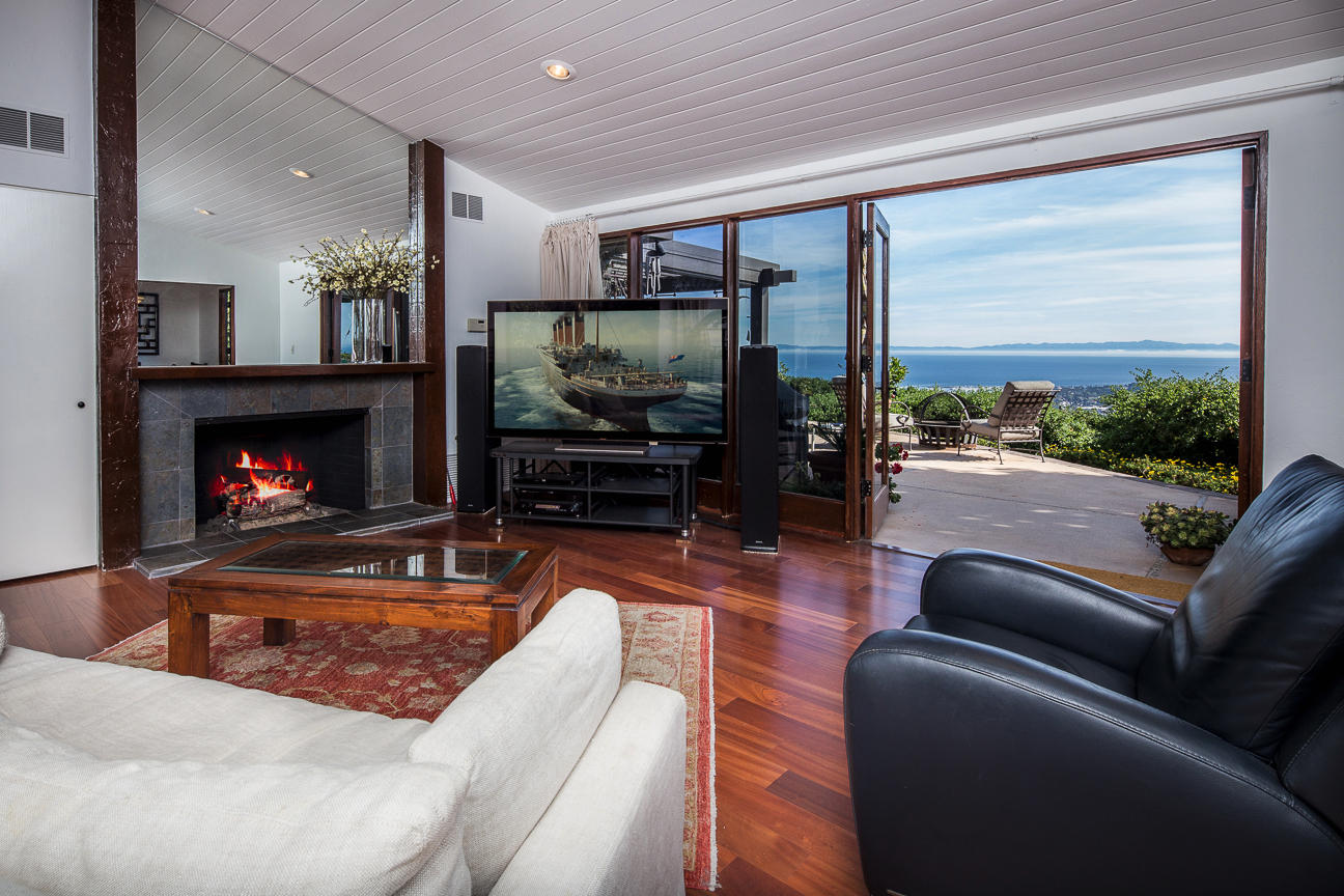 1213 Viscaino Road Santa Barbara, CA 93103 - Photo 3 of 22 a living room with furniture flat screen tv and a fireplace