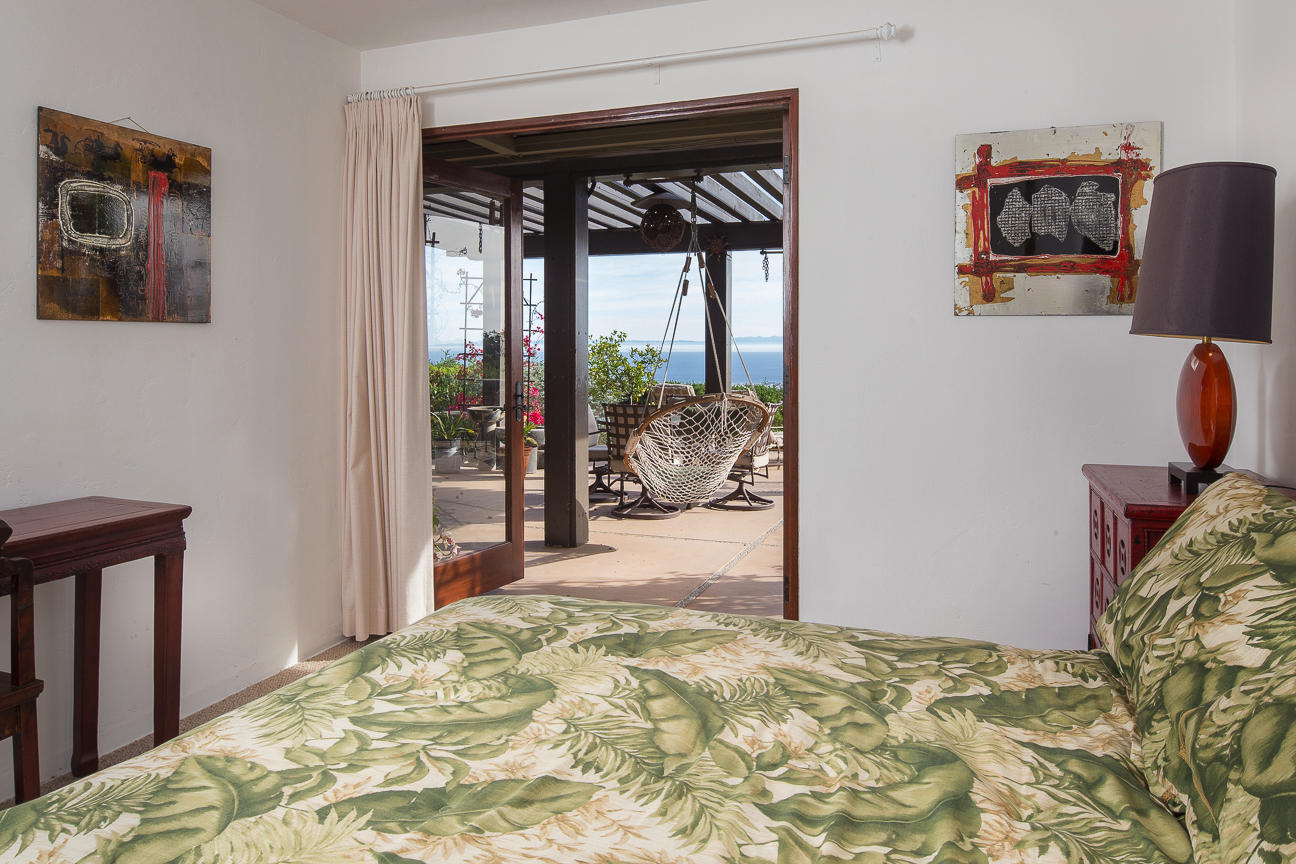 1213 Viscaino Road Santa Barbara, CA 93103 - Photo 8 of 22 a bedroom with a bed and wooden floor