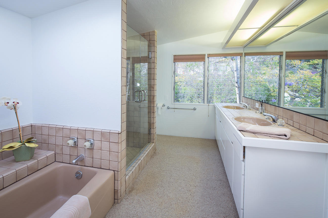 1213 Viscaino Road Santa Barbara, CA 93103 - Photo 10 of 22 a bathroom with a tub sink and mirror