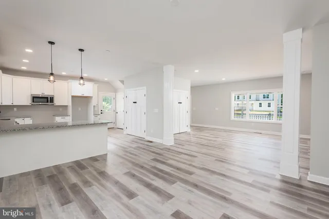 a view of kitchen with wooden floor and electronic appliances