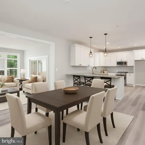 a view of a kitchen with white cabinets
