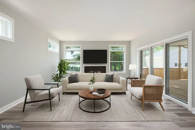 a view of empty room with wooden floor and fireplace