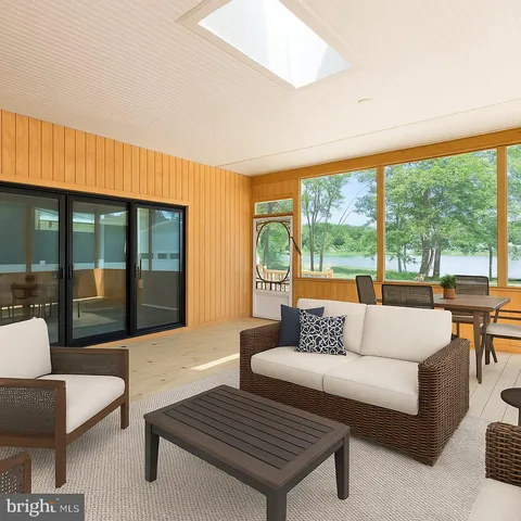 an empty room with wooden floor and large windows