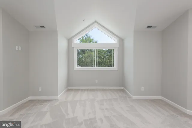 an empty room with windows and closet