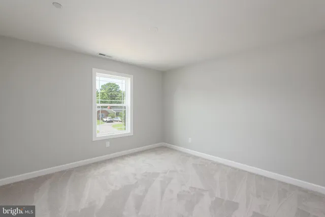 a bedroom with a bed and a chair