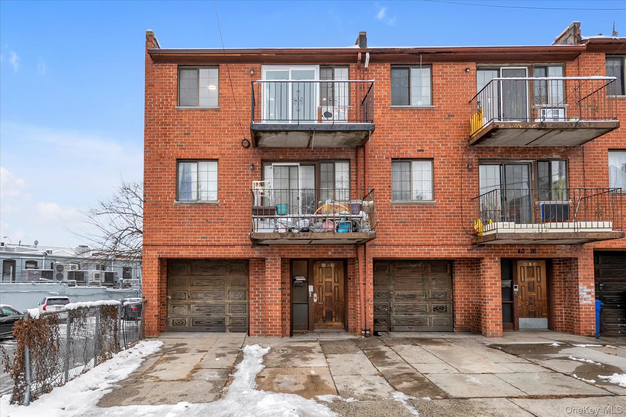 40-18 165th Street Queens, NY 11358 - Photo 1 of 1 a front view of a brick house with many windows