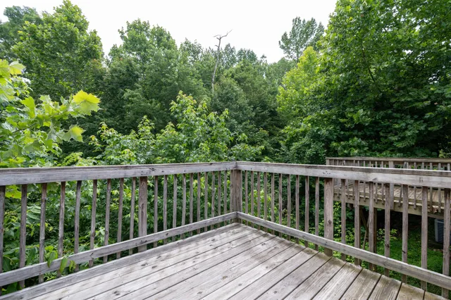 a view of balcony with wooden floor and fence