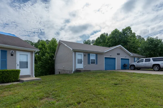 a front view of house with yard and green space