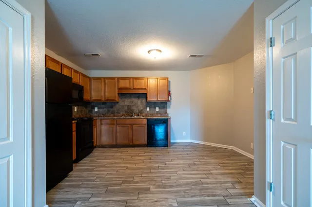 a kitchen with stainless steel appliances granite countertop a refrigerator and a sink