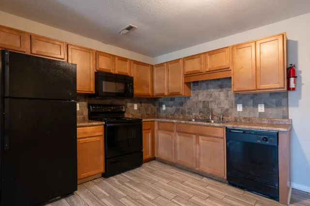 a kitchen with a refrigerator stove and microwave