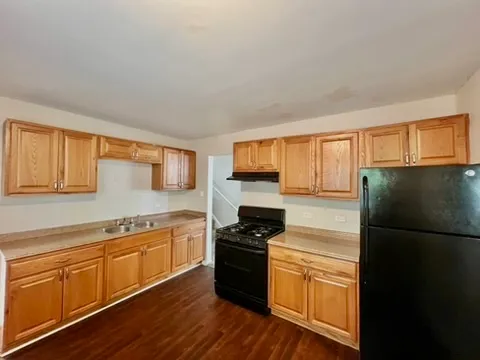 a kitchen with a refrigerator stove and sink