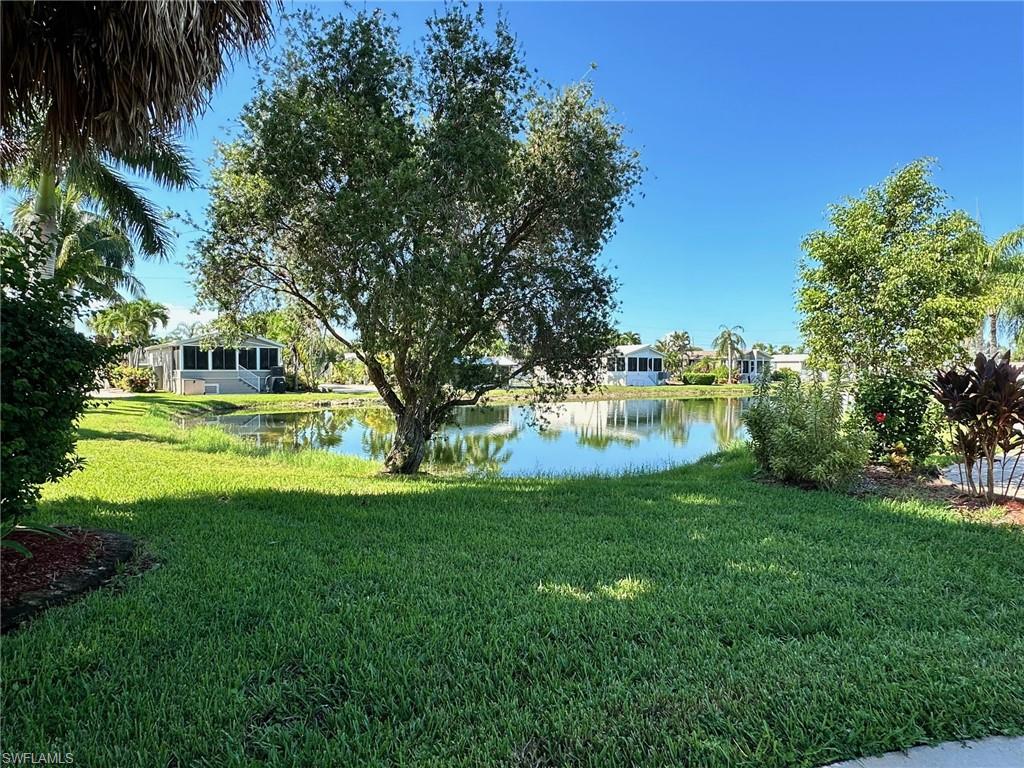 1313 Nickel Lake Point Naples, FL 34114 - Photo 7 of 10 View of grassy yard featuring a water view