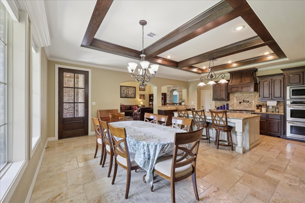 404 Birch View Drive Lumberton, TX 77657 - Photo 13 of 44 a view of a dining room with furniture and a chandelier